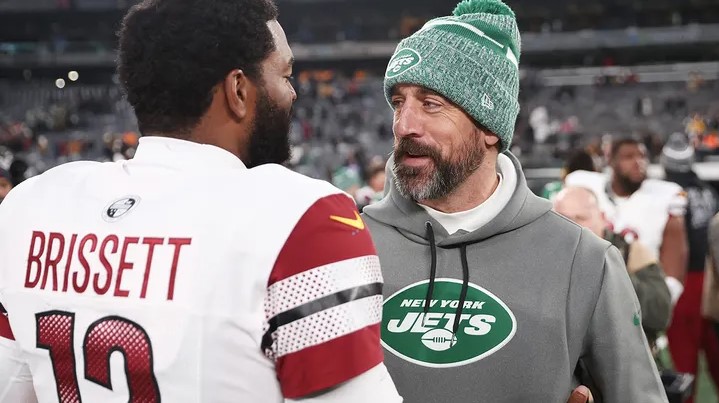 Aaron Rodgers of the New York Jets and Jacoby Brissett of the Washington Commanders meet after a game at MetLife Stadium Dec. 24 2023 in East Rutherford N.J